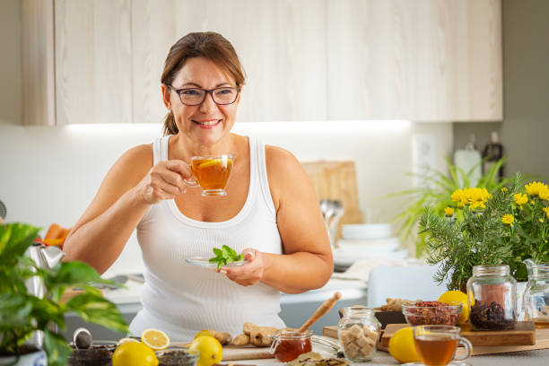 Woman drinking healthy ginger and lemon hot tea