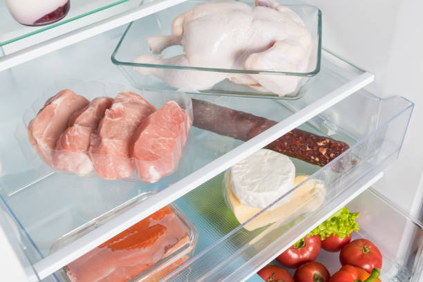 pork steaks and chicken meat are on the shelf in the refrigerator