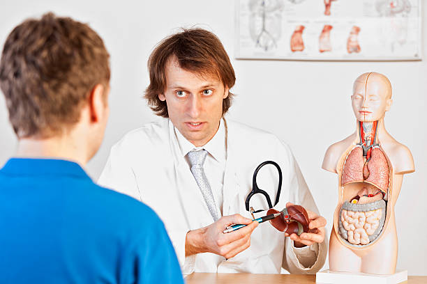 "A medicine, explaining liver problems to a male patient. XXL size image."