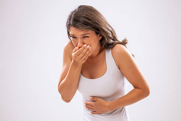 Portrait of adult woman who is having nausea.