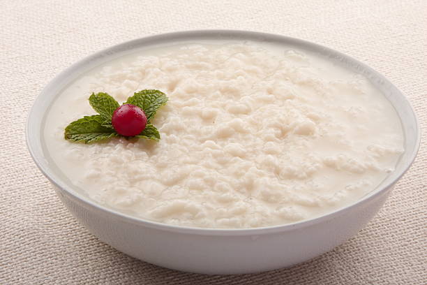 Healthy breakfast.Homemade rice pudding with red plums.