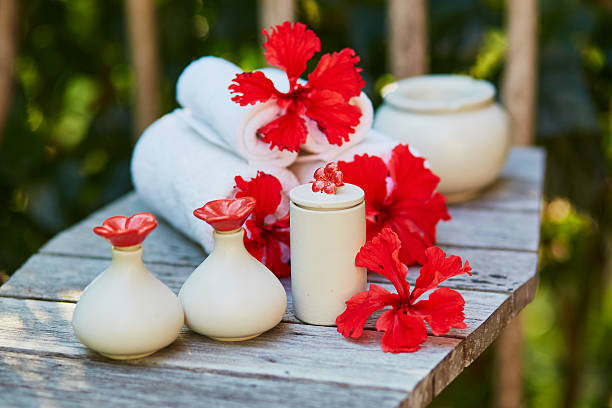 Spa setting with towels and beautiful red hibiscus flowers