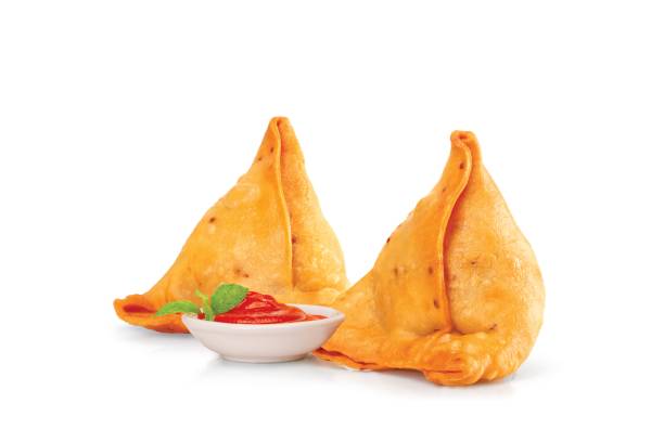 two tasty samosa with tomato sauce