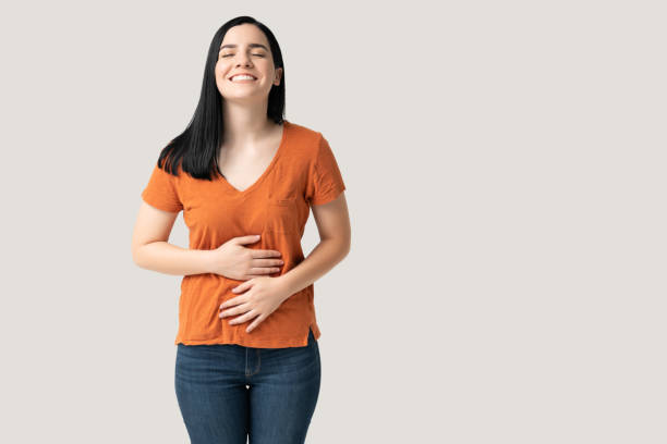Beautiful smiling young woman in casuals satisfied after eating meal